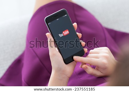 Alushta, Russia - November 22, 2014: Woman holding a iPhone 6 Space Gray with video service YouTube on the screen. iPhone 6 was created and developed by the Apple inc.