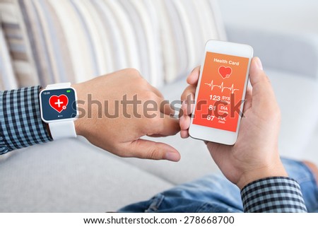 male hands holding touch phone and smart watch with mobile app health sensor