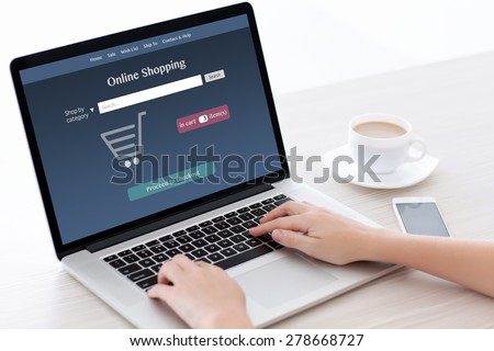 girl sitting at the computer and makes online shopping in a white room