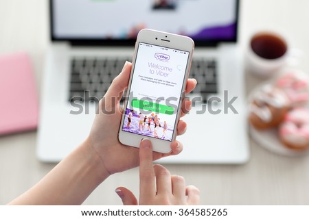 Alushta, Russia - October 29, 2015: Woman holding a iPhone 6S Rose Gold with client messaging and voice service Viber on the screen. iPhone 6S was created and developed by the Apple inc.