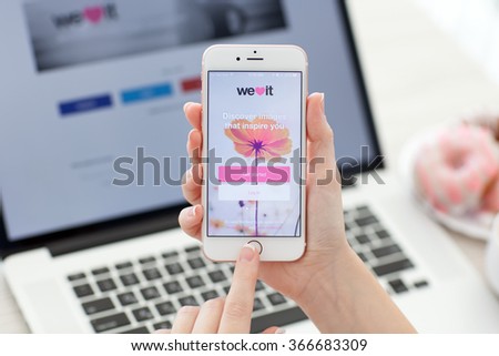 Alushta, Russia - November 1, 2015: Woman holding iPhone 6S Rose Gold with image-based social network service We heart it on the screen. iPhone 6S was created and developed by the Apple inc.