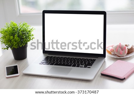 laptop with isolated screen and phone on the desk in the office