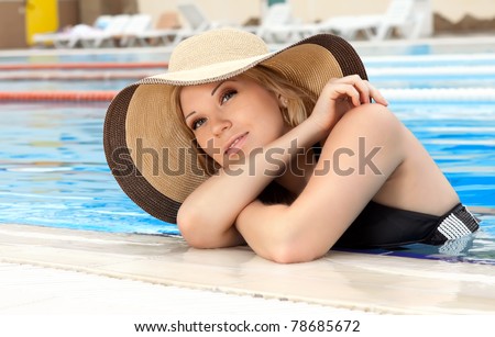 series closeup portrait the smart blonde in a hat in pool of expensive hotel
