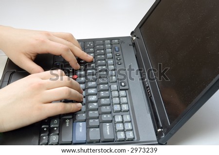 Two hands typing on a black laptop keyboard