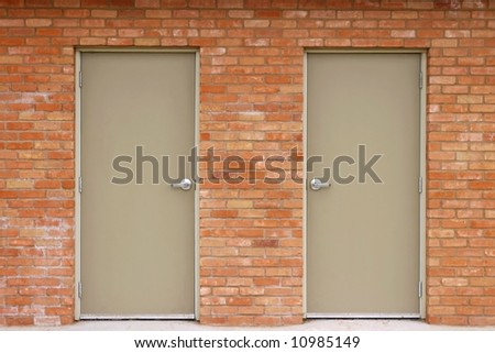 A set of double doors built into a red brick wall