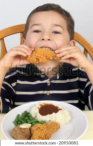 five-year-old boy eating fried chicken