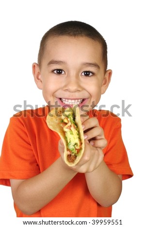 stock photo Sixyearold Hispanic boy with authentic Mexican taco 