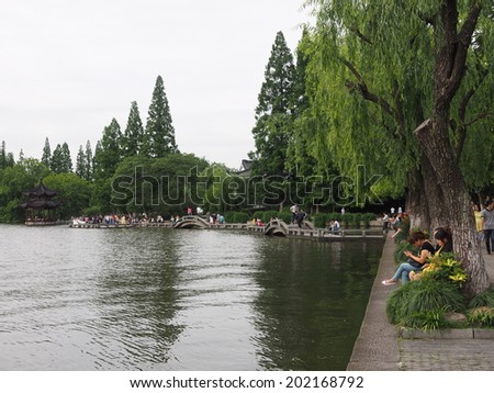 HANGZHOU, CHINA - MAY 22: Visitors visit the infamous West Lake on May 22, 2014 in Hangzhou, China. It was made a UNESCO World Heritage Site in 2011.