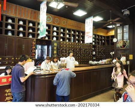 HANGZHOU, CHINA - MAY 22: Visitors visit traditional chinese pharmacy store on May 22, 2014 in Hangzhou, China. It was made a UNESCO World Heritage Site in 2011.