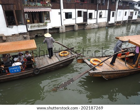 ZHUJIAJIAO, CHINA - MAY 21: Senior man transports recycling material in Chinese gondola on May 21, 2014 in Zhujiajiao.