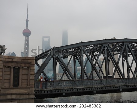 SHANGHAI, CHINA - MAY 19 : Tourists at Waibaidu Bridge on May 19, 2014 in Shanghai, China. The Waibaidu Bridge was constructed in 1907 and was the first steel truss bridge to be built in China.