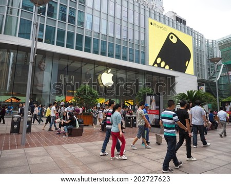 SHANGHAI,CHINA - MAY 24: Tourists at the famous shopping street, Nanjing road, in Shanghai, China on May 24, 2014. Nanjing Road is one of the world\'s busiest and longest shopping district.