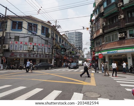 SHANGHAI, CHINA - MAY 19: Narrow alley downtown Shanghai on May 19, 2014. With 23 million citizens Shanghai is China's largest city by population. Its urban area has a very high density.