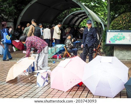 SHANGHAI, CHINA - MAY 18: People post their unmarried children\'s advertisement and photos, boasting their education, salary levels in People\'s Park on May 18, 2014 in Shanghai,China.