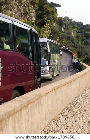 Two buses try to figure out how to pass on a narrow Amalfi road