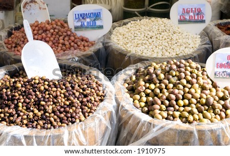 Pickled olives and onions  for sale in an open air market in Italy