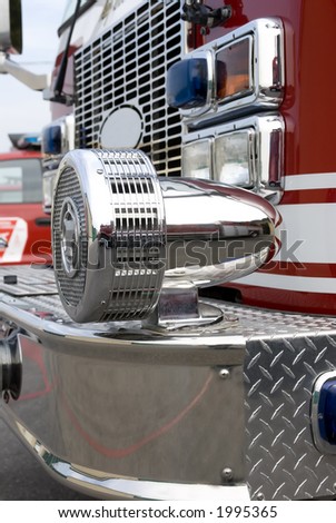 A close up view of a chrome siren on a fire truck