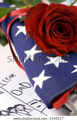 A lone red rose lying on top of a folded American flag. A single tear drop falls from the rose. I miss my daddyâ€¦.my hero.