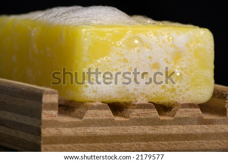 A macro shot of a bar of soap with lots of lather