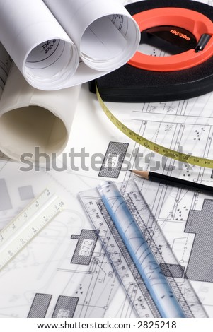 An engineer's work table with drawings and tools of the trade