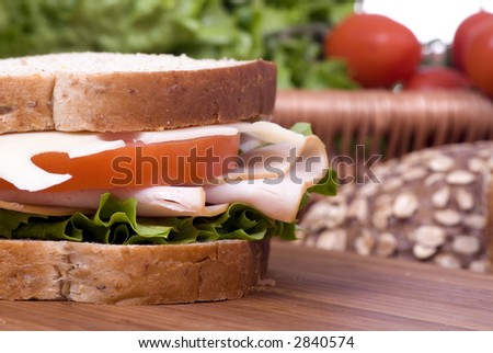A fresh deli sandwich with tomatoes swiss chees, lettuce and lots of meat.