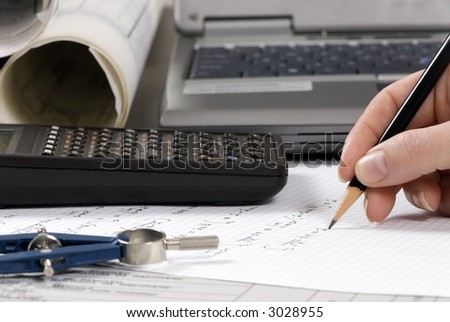 An Engineer calculates the final figures for a design