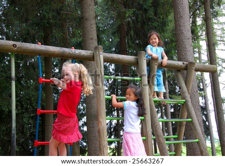 Three young girls playing in a playground. Diversity
