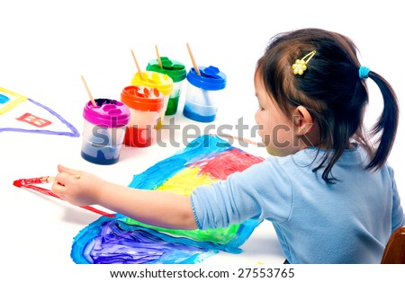 A young asian girl having fun painting a picture