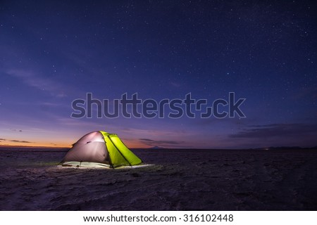 Camping tent at night against amazing sky full of stars, Salar de Uyuni, Bolivia