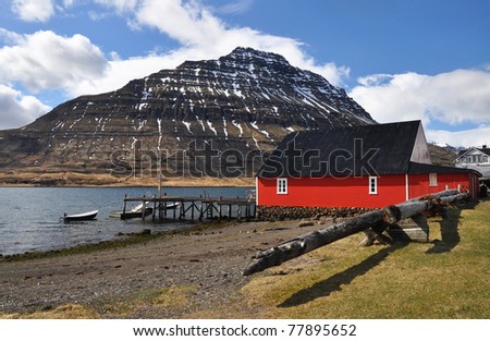 Red house in deep fjord, East fjords, Iceland
