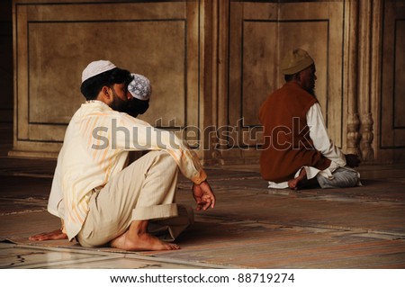 OLD DELHI, INDIA - OCTOBER 25: Muslim men pray in the mosque Jama Masjid on October 25, 2010 in Delhi, India. Jammu Masjid is the largest mosque in whole India.