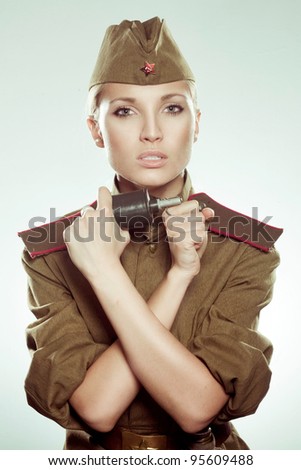 stock-photo-beautiful-girl-in-military-clothes-with-grenade-95609488.jpg