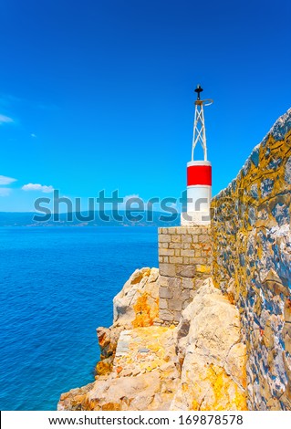 The red port light of the main harbor of Hydra island in Greece