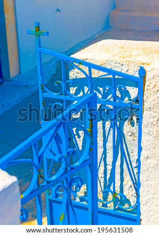 Detail from the iron made blue colored door of an old traditional house in Oia the most beautiful village of Santorini island in Greece