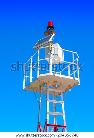 The red port light tower of Marina Flisvos in Athens Greece