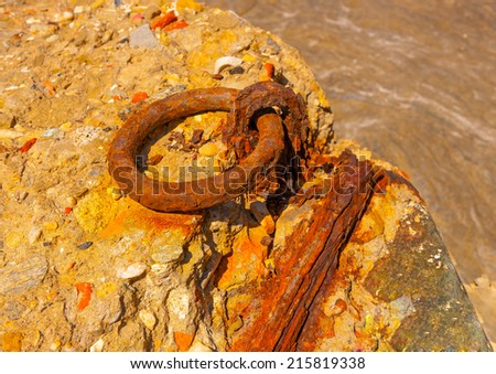 rusty boat link on the dock  at the sea in front of Chora, the capital of Andros island in Greece