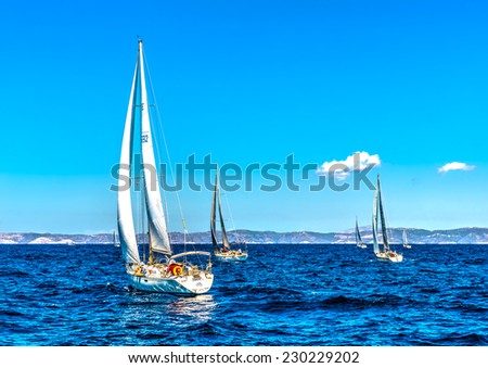 AEGEAN SEA, GREECE - JUN 2, 2013: Racing sailing boats during a regatta at Aegean sea near Kea island in Greece on Jun 2, 2013. HDR processed