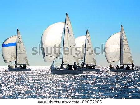 Sailing regatta in Greece: Four back-lighted boats with spinnakers open