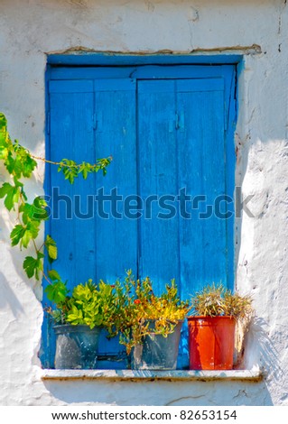 Blue colored window from  an old Greek house in Skiathos