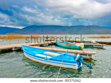 Traditional old wooden fishing boats in the lake Prespa near Psarades village in northern Greece