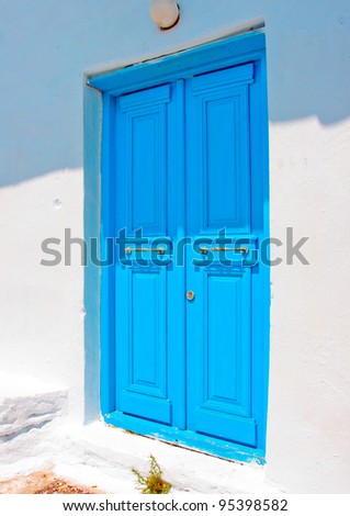 A wooden blue colored door of a Beautiful traditional house in Chora the capital of Amorgos island in Greece