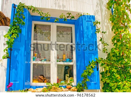 Beautiful wooden blue colored window in an old house in Chora of Amorgos island in Greece