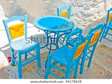Old traditional beautiful iron made round shaped small coffee table and chairs out of a cafe in Chora the capital of Amorgos island in Greece