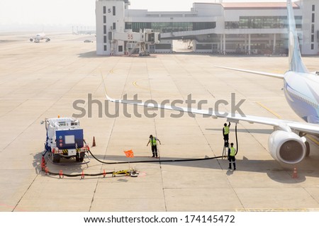 Airplane in airport serviced by the ground crew