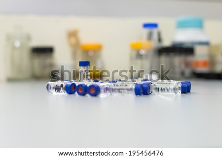 Used vials in the analytical instrument on the laboratory bench