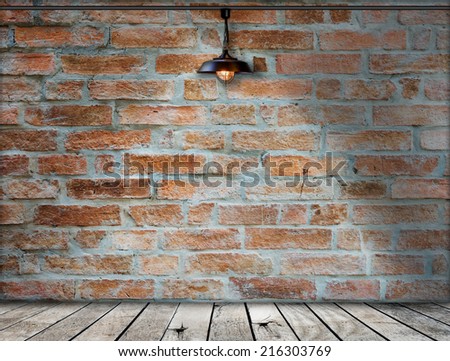 Lamp at brick wall background with ground wood, defocused brick