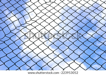 Silhouette wired fence with blur cloud and blue sky background