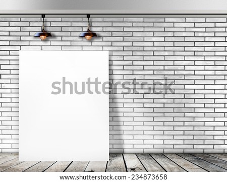 Poster standing in White Brick wall with Ceiling lamp