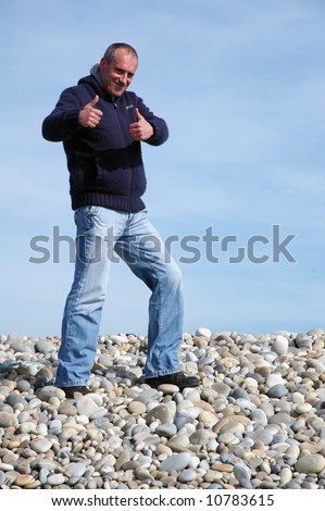 young man thumb up at the beach
