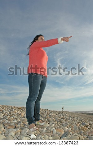 young girl pointing her finger to sky